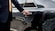 A driver opens the door to a sedan